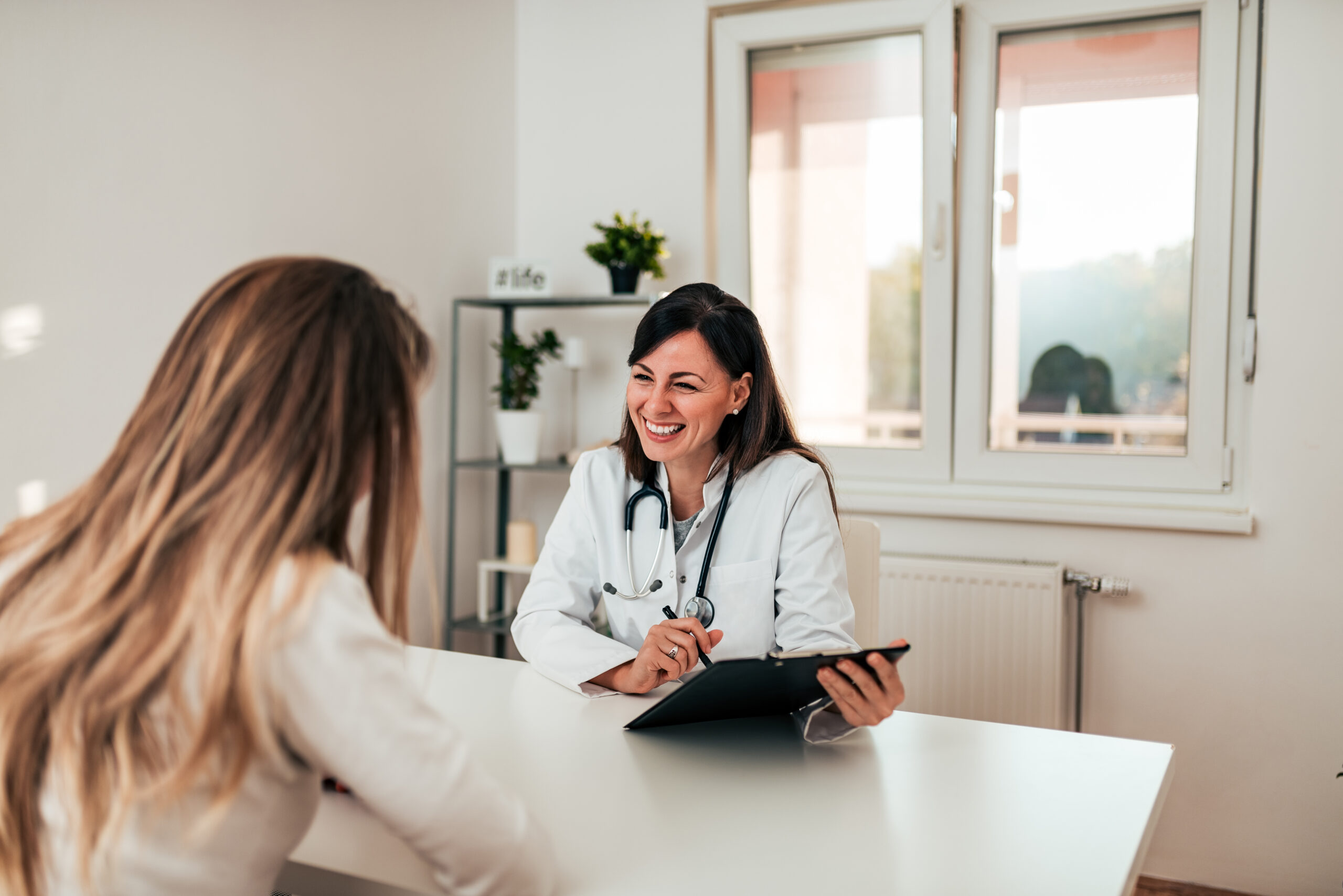 Young doctor and patient talking in the doctor's office.